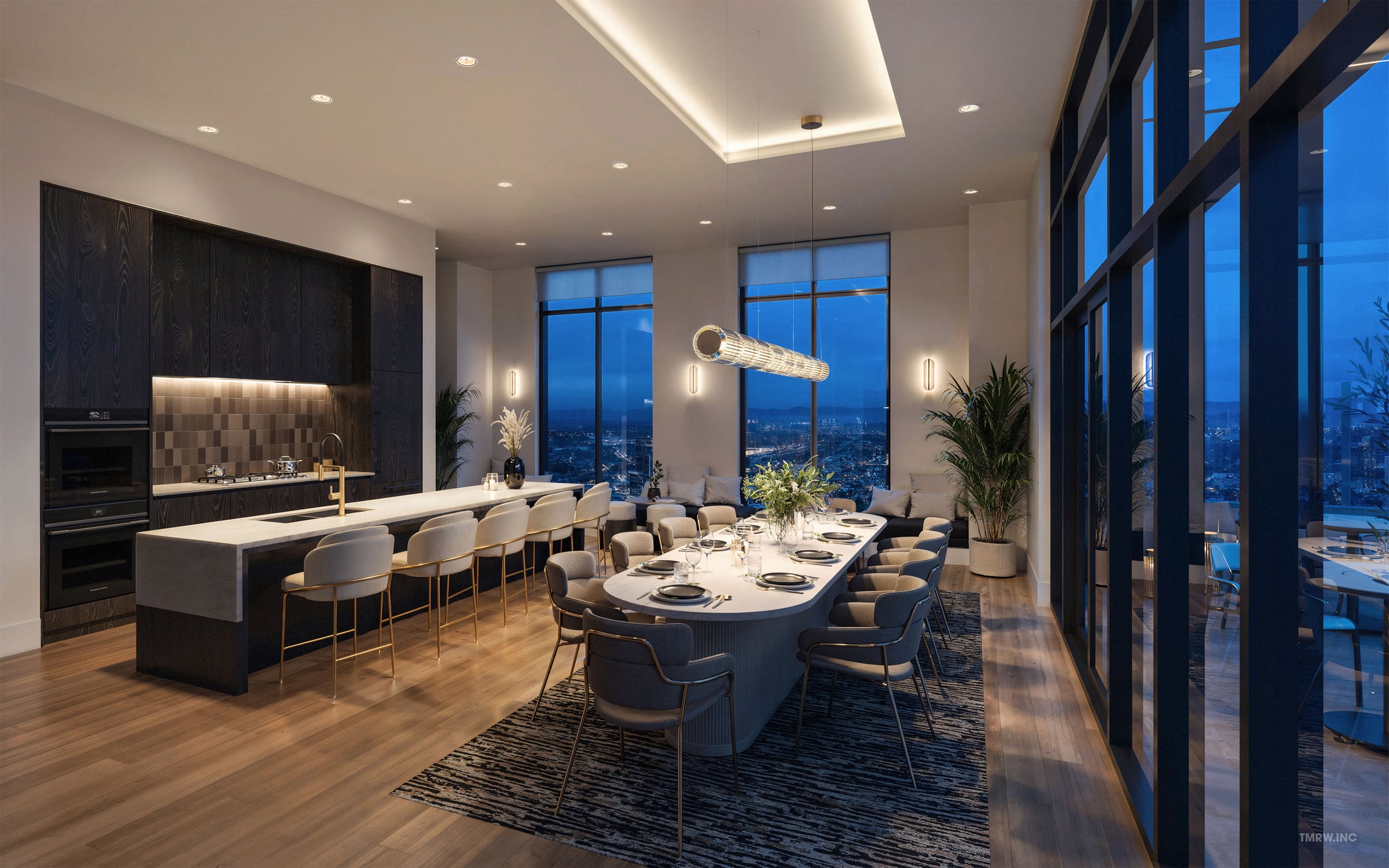 Shared kitchen and dining room with a long island and pendant lights