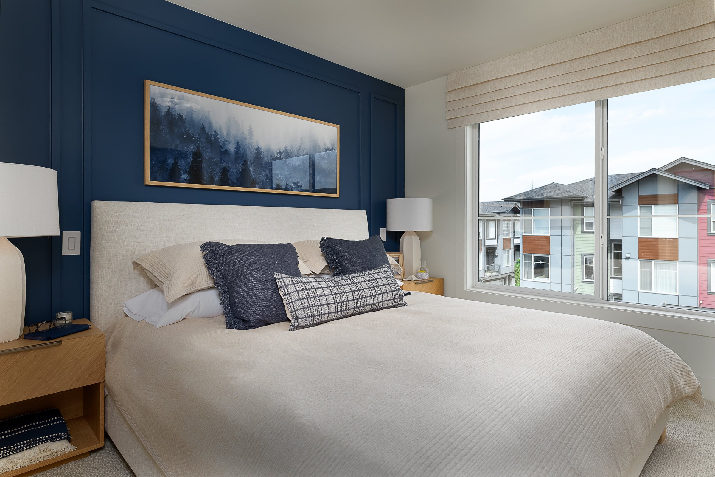 Primary bedroom with a navy feature wall