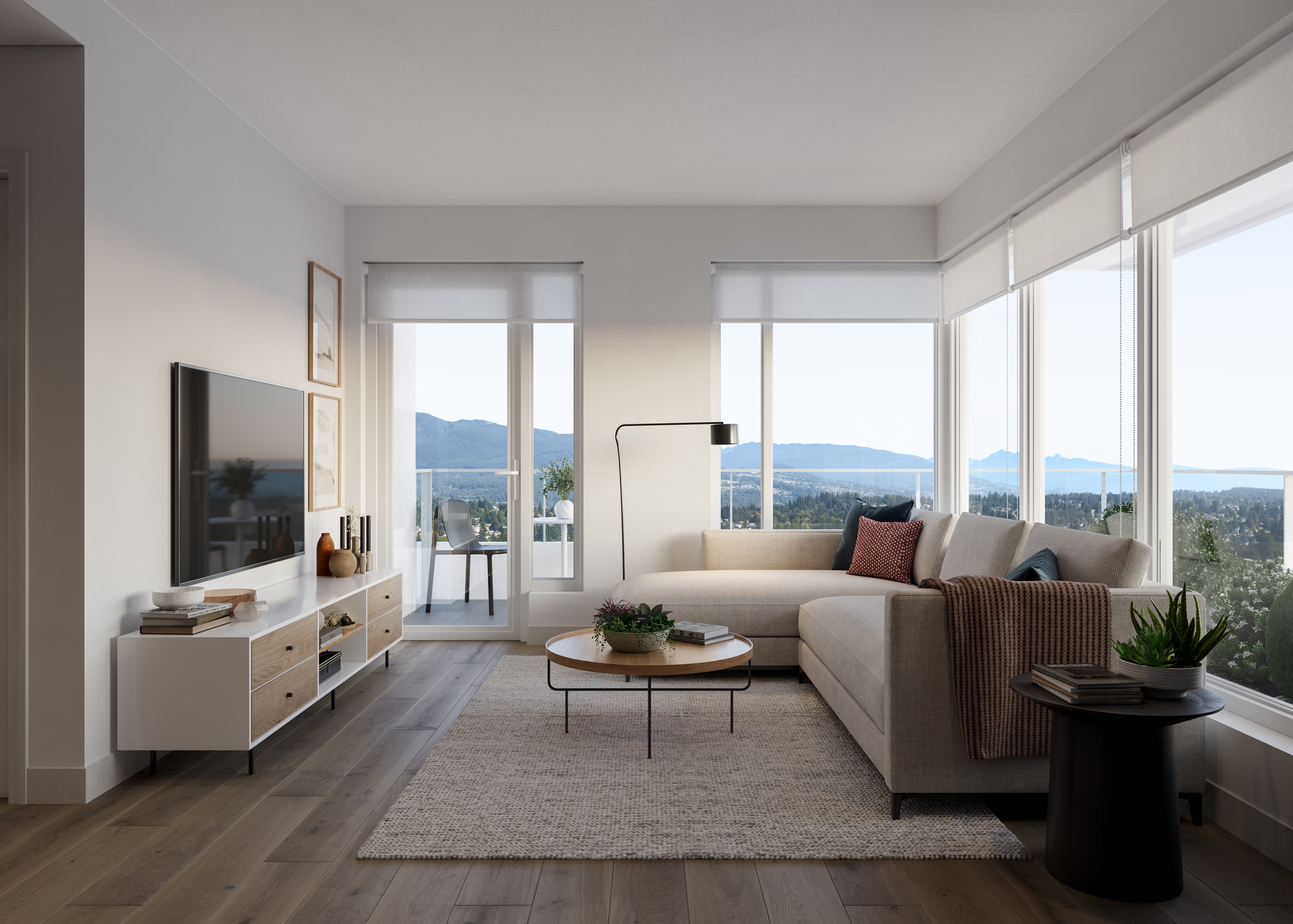 Living room with floor to ceiling windows, looking out to the mountains and the water