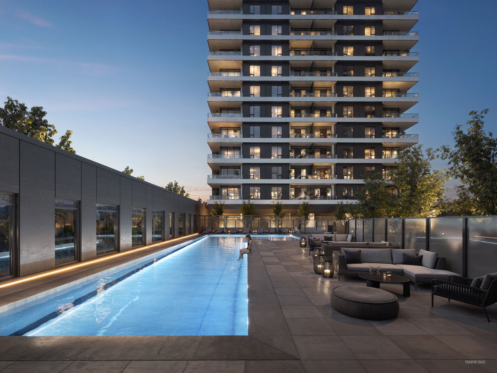 The outdoor pool at dusk, with loungers and cabanas on the podium terrace